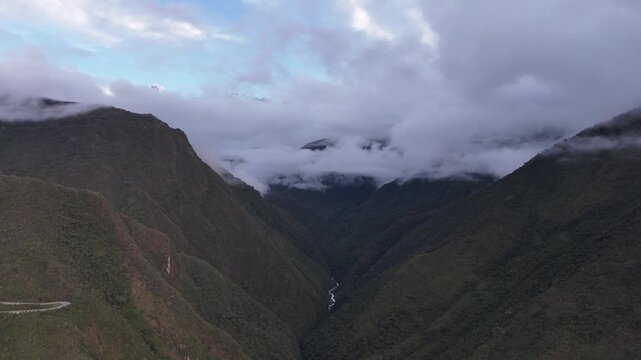 Aerial footage moving into the clouds and revealing the majestic, sacred Salkantay peak 6,271 meters  in the Peruvian Andes. A key landmark on the Salkantay Trek
