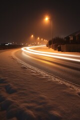 Obraz premium Night road curve with snow and light trails