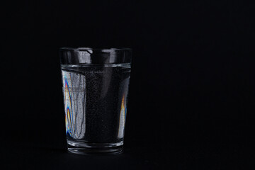 Minimalist Glass of Water with Bubbles on Black