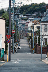 Fototapeta premium Residential street with dense building and electric poles wires in suburban of Japan