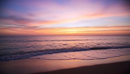 Fototapeta premium Peaceful beach sunset with gentle ocean waves and pastel-colored sky reflecting on wet sand 