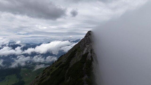Aerial view of a mountain ridge disappearing into dense fog, Dachstein, Austria