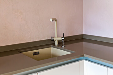 Kitchen interior. Modern kitchen sink featuring sleek faucet and stylish countertop in pastel colors, creating serene ambiance in contemporary kitchen space with clean lines and minimalistic design