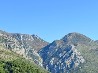 Mountain landscape under blue sky with rocky hills