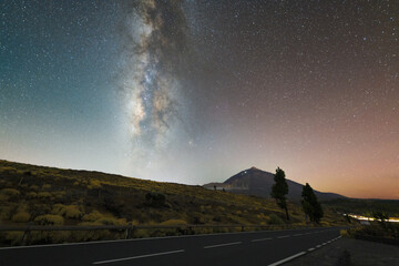 Stunning night sky over Mount Teide in Tenerife, Canary Islands. The Milky Way arches across the sky above the volcanic landscape of Teide National Park. A breathtaking astrophotography scene perfect 