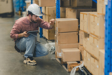 Warehouse worker working in warehouse storage. Foreman or worker work at factory site check up products in site. Inventory worker working in  factory Storehouse
