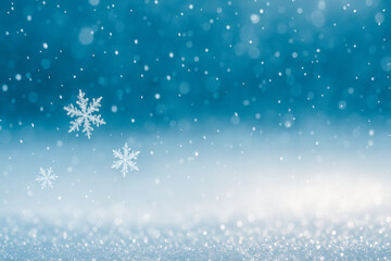 Fototapeta premium Horizontal close-up image of falling snowflakes set against a cool blue gradient background. The softly blurred flakes and bokeh lights create a dreamy, festive winter mood — ideal for holiday cards