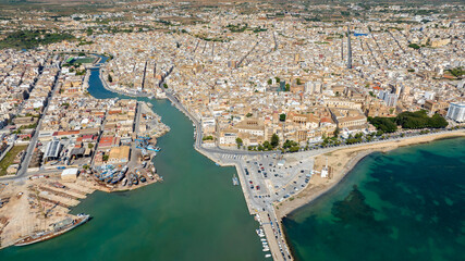 Fototapeta premium Aerial view of Mazara del Vallo, a town in the province of Trapani, Sicily, Italy. Overlooking the Mediterranean Sea at the mouth of the Mazaro River, it is an important Mediterranean fishing port.