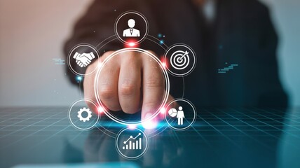 Business professional interacting with a digital interface displaying business strategy icons, symbolizing innovation and growth.