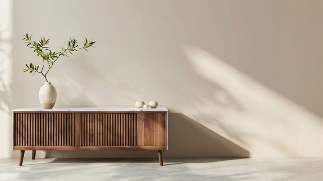 Wooden sideboard with white marble top, vase with leaves, minimalist design, beige wall, sun shadow