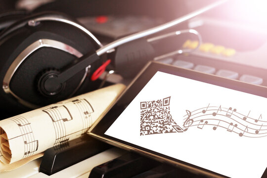 Headphones and a smartphone with an image of notes. - Powered by Adobe