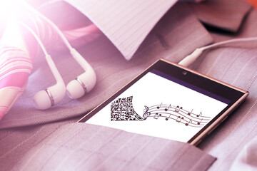 Headphones and a smartphone with an image of notes.