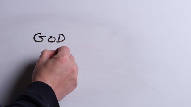 A person is writing God Hears You in black marker pen on a whiteboard, perfect for Christian, religious themes, Church communications or faith presentations