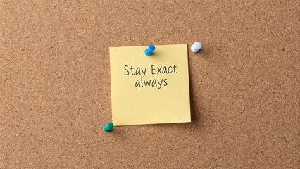 Sticky Note with Stay Exact Message on Cork Board Background