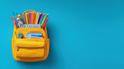 Bright yellow backpack filled with school supplies on a solid blue background, ideal for education, back-to-school themes, and promotional materials.