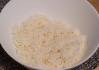 Close up shot of the cooked white rice in the bowl. Food