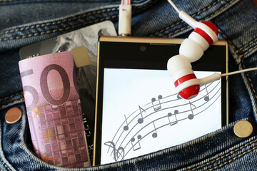 Headphones and a smartphone with an image of notes.