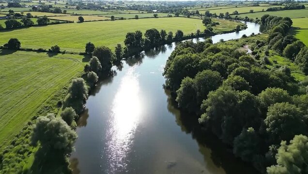 Top-down aerial of winding river through green landscape