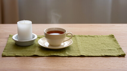 Cozy afternoon tea setting with candlelight on a soft tablecloth