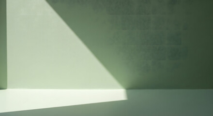 Sunlight and shadow creating graphic shapes on a green surface, Abstract minimalist background with light and shadow on a textured green wall