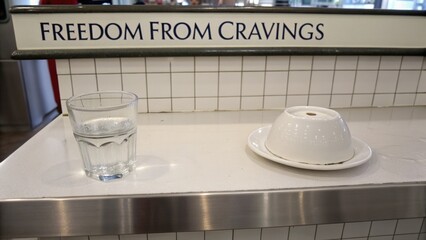 Glass of Water and Upside Down Sugar Bowl on a Kitchen Bench