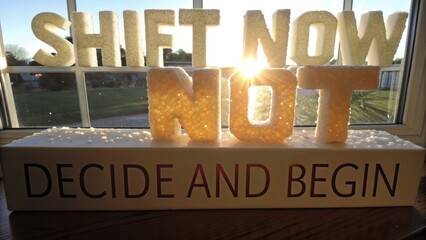 Glowing Shift Now Letters Displayed in Bright Sunlight