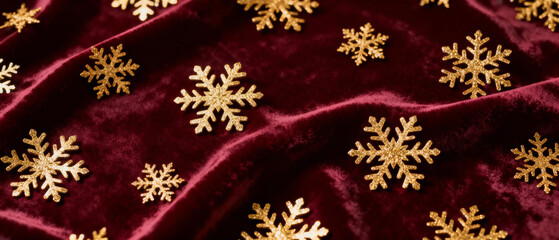 Gold snowflakes on burgundy velvet background for holiday decor  