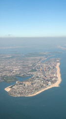 Aerial view of coastal cityscape with beaches and ocean horizon concept of travel agency, tourism board, real estate firm