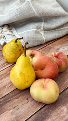 Fresh pears and peaches on rustic wooden table for organic grocers and farmers markets concept of farm-to-table