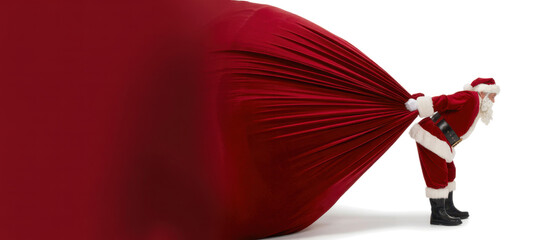 Santa Claus pulling huge bag of presents isiolated on white background with copy space
