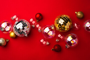 Festive Christmas ornaments on a red background.