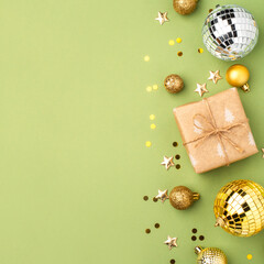 Christmas gift with gold ornaments on a green background.