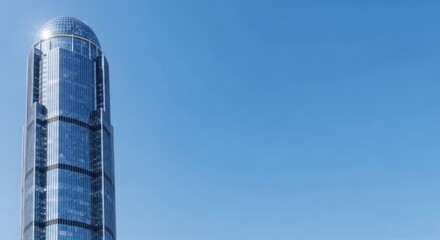 Gleaming spire of modern architecture, reaching towards the clear blue sky