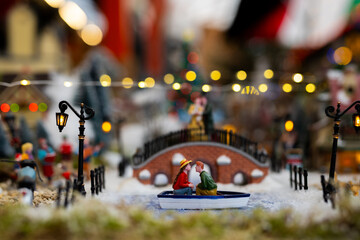 Obraz premium Romantic Miniature Boat Ride in Winter Village