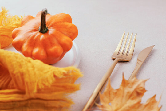 Autumn dinner setup with yellow napkin and squash