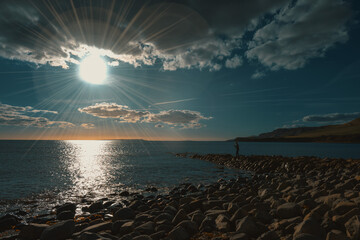 Dramatic sunset over rocky seashore