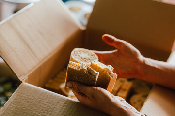 warmly packaging artisan crafted pottery with natural materials in cozy studio setting for shipping