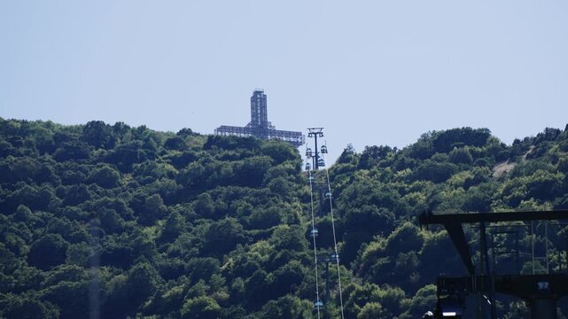 Panoramic view of Skopje Vodno cross with cable car gondola lift transportation under clear sky
