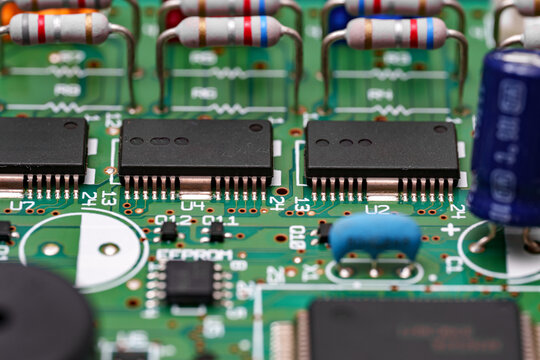 Electronic circuitry intricate design displaying resistors, chips, and capacitors on a green board