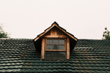 Rustic Wooden Dormer Window on Tiled Roof