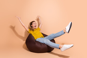 Excited young woman enjoying leisure on a beanbag chair in a vibrant setting