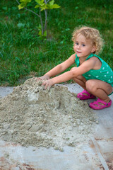 Children play with sand on the street. Selective focus.