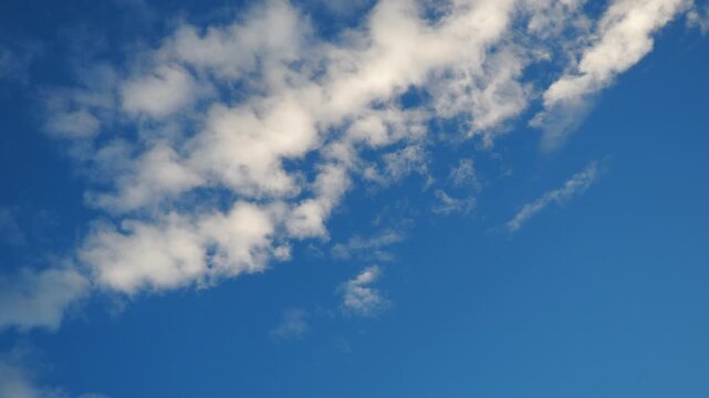 Altocumulus high cumulus heaped cloud genus strato cumuliform. Globular masses or rolls in layers or patches. Cumuliform stratocumuliform clouds, altocumulus signifies convection. Blue sky. Sunlight