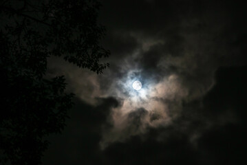 Full Moon Behind Dark Clouds At Night