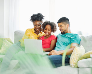 Mother, father and daughter doing homework with laptop at home. Mom, dad and teenage black girl happy using laptop. Teen girl and parents sitting at home working with notebook