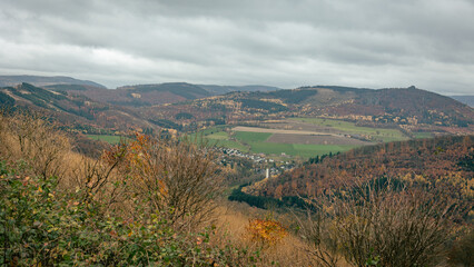 Hiking in Germany in the Sauerland region in the state of North Rhine-Westphalia, on the hills of the Rothaarsteig in November with beautiful autumn colours