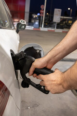 Man Refueling a Car at Gas Station