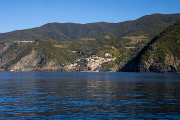 Panoramic view of the Ligurian coast and the colorful villages of Cinque Terre as seen from the sea on a cruise ship on a clear day. Cinque Terre, Liguria, Italy