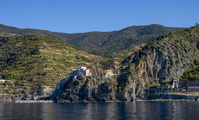 Panoramic view of the Ligurian coast and the colorful villages of Cinque Terre as seen from the sea on a cruise ship on a clear day. Cinque Terre, Liguria, Italy