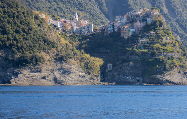 Panoramic view of the Ligurian coast and the colorful villages of Cinque Terre as seen from the sea on a cruise ship on a clear day. Cinque Terre, Liguria, Italy